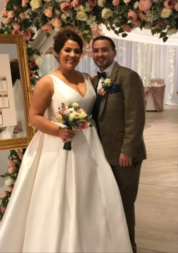 Bride and groom with bespoke Bolton wedding flowers by Virginia Carmen Designs