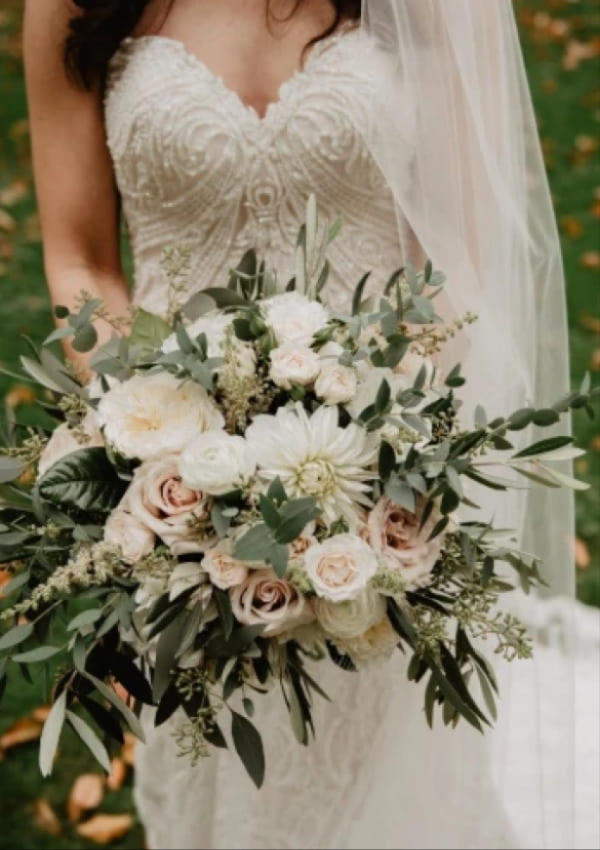 Bride holding a handcrafted Virginia Carmen Designs wedding bouquet