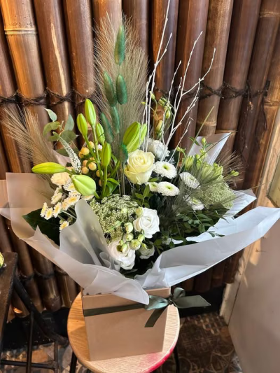 Pure Grace - Elegant white blooms, creamy tones, and lush greens come together in a sophisticated bouquet that exudes tranquility and refinement. This timeless arrangement is ideal for celebrating all occasions understated beauty and heartfelt appreciation. Picture shown is large size