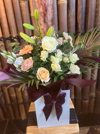 Peachy Affection - A medley of peaches and cream seasonal flowers expressing heartfelt affection. Touches of salmon and pale green bring depth and warmth. let our florist design you something in this sophisicated and vintage feel design Picture shown is Large size