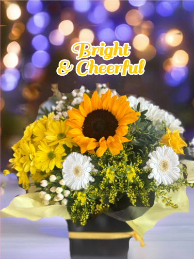 Bright & Cheerful - Our bright and cheerful bouquet is a radiant expression of joy, carefully crafted with florist's choice seasonal flowers in a harmonious blend of sunny yellows and pristine whites. This vibrant arrangement is designed to uplift spirits and bring a touch of sunshine to any space. Please note that due to the natural availability of flowers, some varieties may vary depending on the season. Rest assured, our skilled florists will always select the freshest and most beautiful blooms to create a stunning bouquet that captures the essence of the season.
