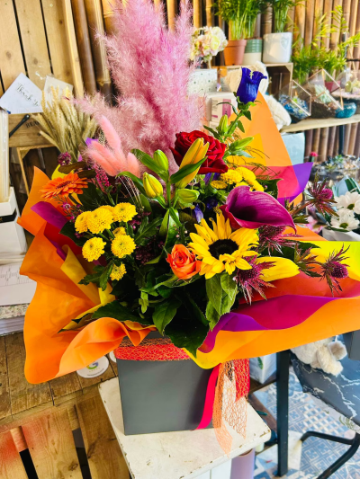 Bright as a Button - Bright as a button, designed to infuse your space with vibrant energy. A carefully chosen selection of mixed seasonal flowers bursts forth with colour, ready to bring light and joy into any room. Please note that flower availability can fluctuate, especially during peak seasons. Rest assured, our professional florists are committed to creating a beautiful and balanced bouquet for you. If certain flowers are unavailable, we will thoughtfully substitute them with equally stunning blooms of the same value, ensuring your bouquet remains a radiant and delightful expression. Picture Shown is Large Size