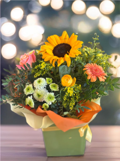 Summer Breeze - meticulously crafted with the freshest and most vibrant flowers to convey your deepest appreciation. Each arrangement is thoughtfully designed, ensuring a breathtaking visual experience from the moment it's received. Imagine a radiant explosion of orange and yellow blooms, creating a warm and inviting ambiance that perfectly capturesd While the exact flower types may vary slightly due to seasonal availability, the overall style and cheerful color scheme will remain consistent, promising a gift that truly delights and leaves a lasting impression.