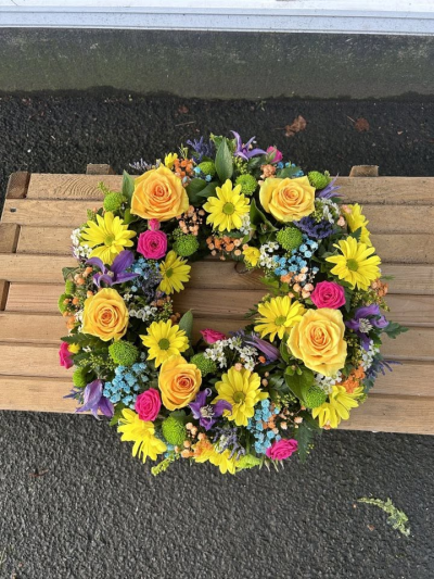 Vibrant Wreath - A vibrant funeral wreath bursting with bright, uplifting colours.