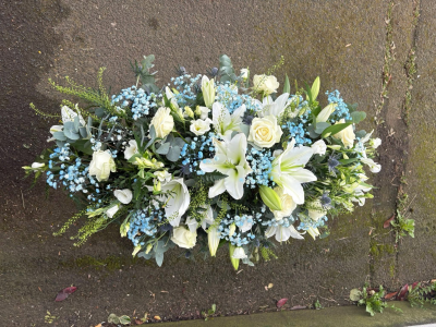 Peace & Serenity - A graceful funeral arrangement in crisp white, soft blue and natural green tones.